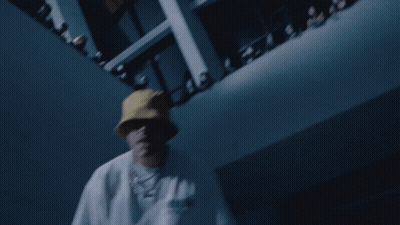 A Man Wearing A Yellow Hat And A White Shirt With The Word Adidas On It Is Dancing In Front Of A Crowd GIF
