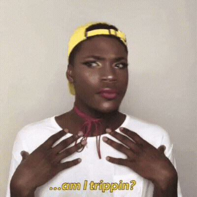 A Man Wearing A Yellow Hat And A White Shirt With The Words Am I Trippin Written On It GIF