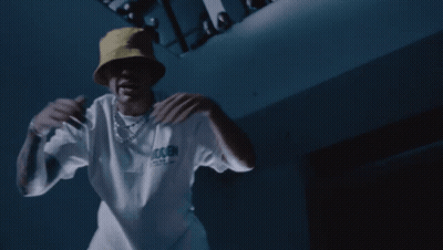 A Man Wearing A Yellow Hat And A White T-Shirt That Says Trash GIF