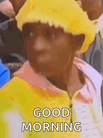 A Man Wearing A Yellow Hat And A Yellow Jacket Is Giving A Good Morning Greeting . GIF