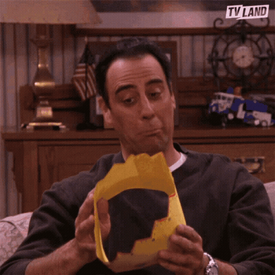 A Man Wearing A Yellow Hat With A Tv Land Logo On It GIF