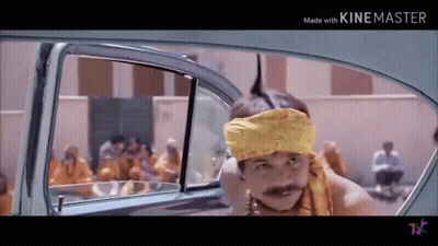 A Man Wearing A Yellow Headband And A Mustache Is Sitting In The Back Of A Car . GIF
