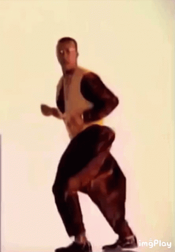 A Man Wearing A Yellow Jacket And Black Pants Is Dancing . GIF