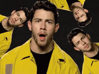 A Man Wearing A Yellow Jacket Is Surrounded By Other Men GIF