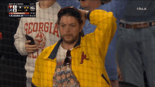 A Man Wearing A Yellow Jacket With Georgia On It GIF