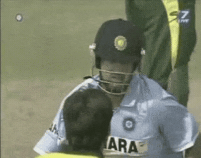 A Man Wearing A Yellow Jacket With The Name Afridi On It Talks To Another Man GIF