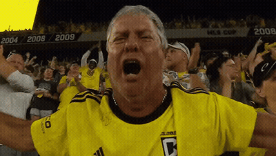 A Man Wearing A Yellow Jersey With The Letter C On The Front GIF
