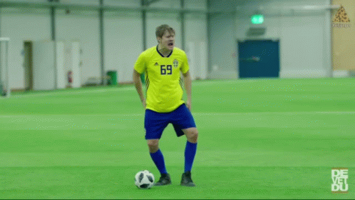 A Man Wearing A Yellow Jersey With The Number 1 On It Is Laughing With His Eyes Closed . GIF