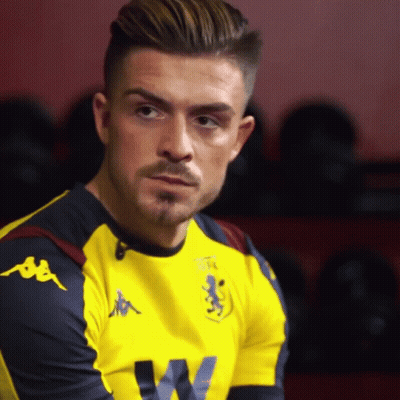 A Man Wearing A Yellow Kappa Shirt Looks To The Side GIF
