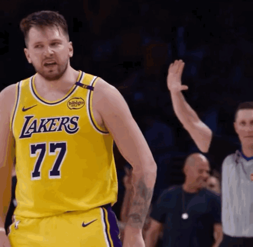 A Man Wearing A Yellow Lakers Jersey With The Number 77 GIF