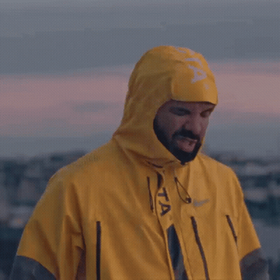A Man Wearing A Yellow Raincoat With A Hood GIF