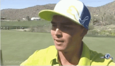 A Man Wearing A Yellow Shirt And A Blue And White Hat With The Word Puma On It GIF