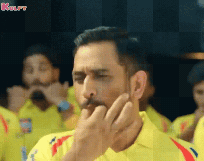 A Man Wearing A Yellow Shirt Is Covering His Mouth With His Hand And The Word Kulfy Is On The Bottom GIF