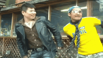 A Man Wearing A Yellow Shirt That Says Brasil Is Standing Next To Another Man GIF