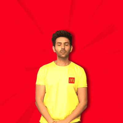 A Man Wearing A Yellow Shirt With A Mcdonald 'S Logo On It Says Let 'S Go Eat GIF