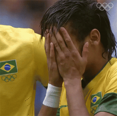 A Man Wearing A Yellow Shirt With The Olympic Rings On It GIF