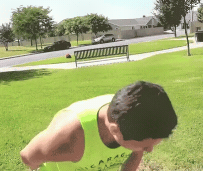 A Man Wearing A Yellow Tank Top That Says Garag On It GIF