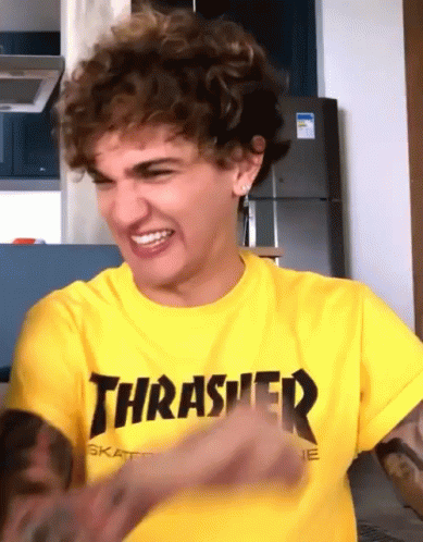 A Man Wearing A Yellow Thrasher Shirt Is Making A Face GIF