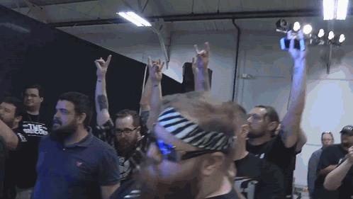 A Man Wearing A Zebra Print Headband Holds Up His Hands GIF