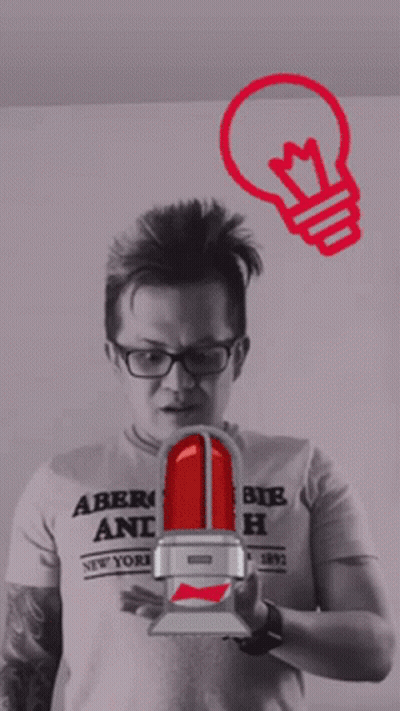A Man Wearing An Abercrombie And Fitch Shirt Holds A Light Bulb GIF