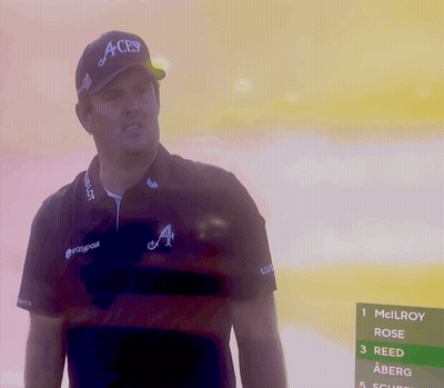 A Man Wearing An Aces Hat Stands In Front Of A Screen GIF