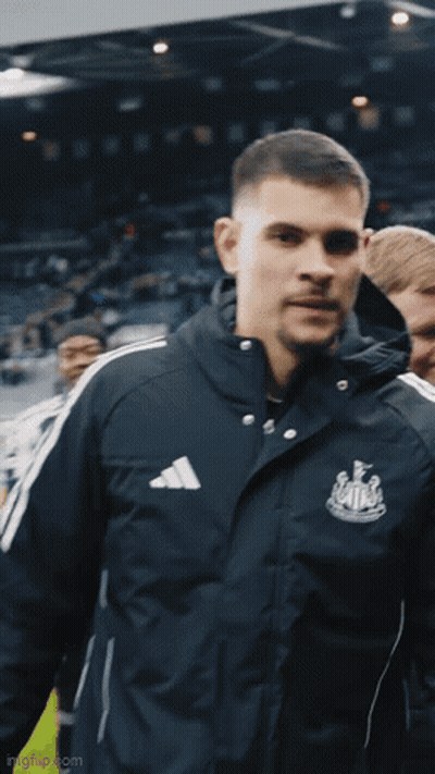 A Man Wearing An Adidas Jacket Is Standing In A Crowd GIF