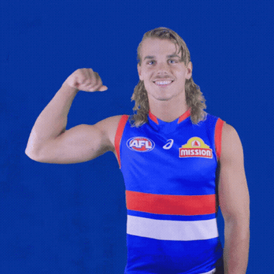 A Man Wearing An Afl Jersey Is Flexing His Muscles GIF