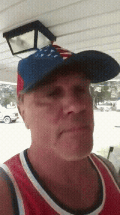 A Man Wearing An American Flag Hat And A Red White And Blue Shirt GIF