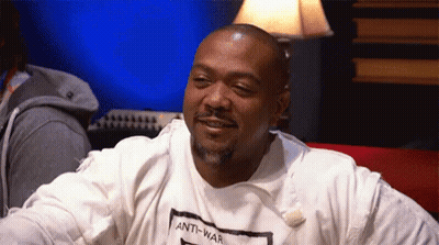 A Man Wearing An Anti-War T-Shirt Is Smiling GIF