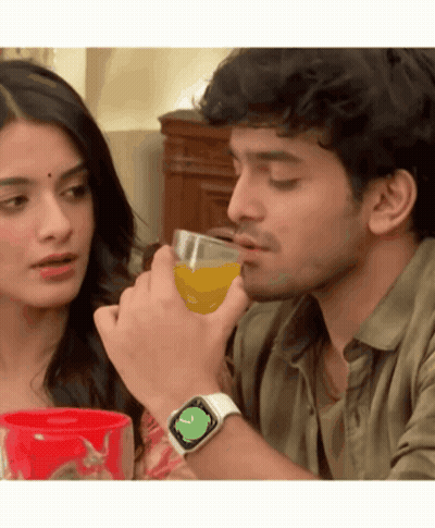A Man Wearing An Apple Watch Is Drinking Orange Juice Next To A Woman GIF