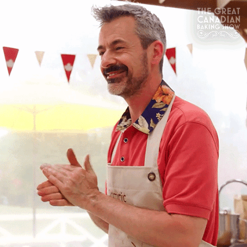 Man In Red Shirt Clapping In Front Of Baking Show GIF