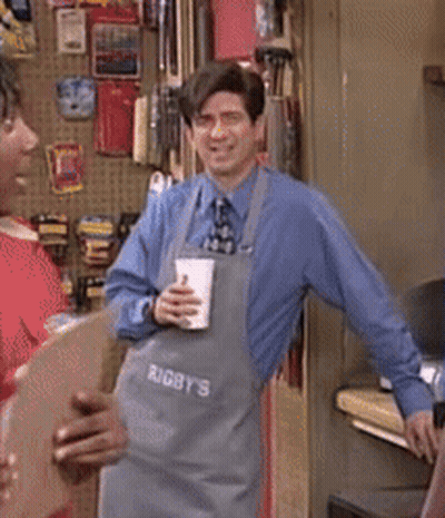A Man Wearing An Apron That Says " Rigby 'S " On It GIF