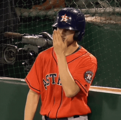 A Man Wearing An Astros Jersey Covers His Face With His Hand GIF