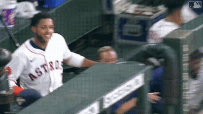 A Man Wearing An Astros Jersey Is Standing In The Dugout GIF