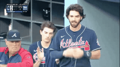 A Man Wearing An Atlanta Braves Jersey Stands In A Dugout GIF