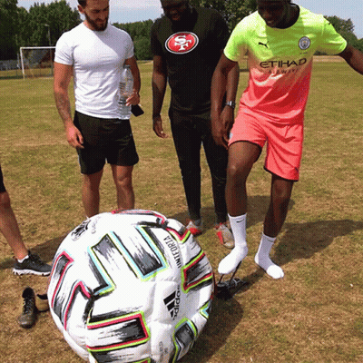 A Man Wearing An Etihad Airlines Jersey Stands Next To A Soccer Ball GIF