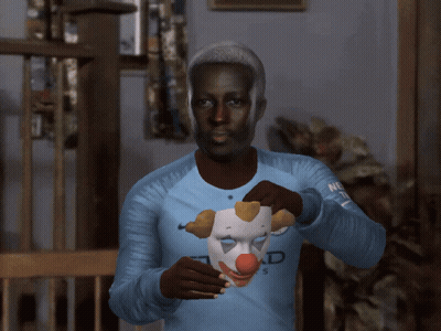 A Man Wearing An Etihad Airways Jersey Holds A Clown Mask Over His Face GIF