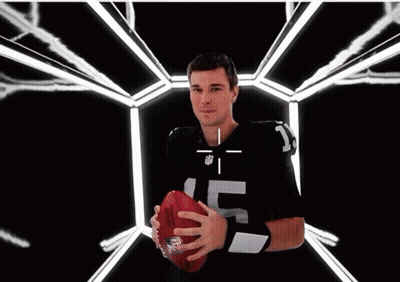 A Man Wearing An NFL Jersey Is Smiling With A Target On His Face GIF