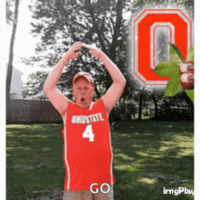 A Man Wearing An Ohio State Jersey With The Number 4 On It Stands In Front Of An Ohio State Logo GIF