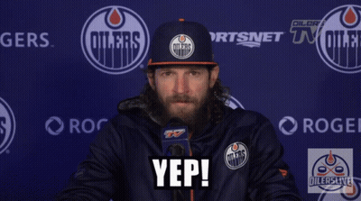 A Man Wearing An Oilers Hat Says Yep In Front Of A Blue Wall GIF