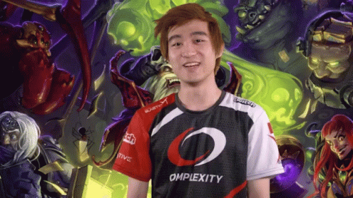 A Man Wearing An Omplexity Shirt Stands In Front Of A Painting GIF