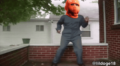 A Man Wearing An Orange Hat With Ny On It GIF