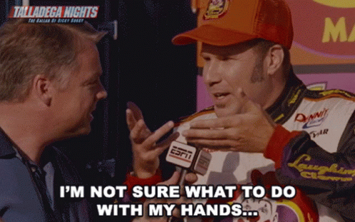 A Man Wearing An Orange Hat With The Word Talladega On It GIF