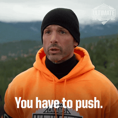 A Man Wearing An Orange Hoodie And A Black Beanie Says " You Have To Push " GIF