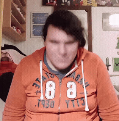 A Man Wearing An Orange Hoodie That Says ' T930 Yt13 ' On It GIF