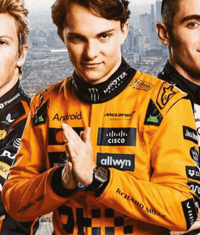 A Man Wearing An Orange Jacket With Logos For Android Cisco And Allwyn GIF