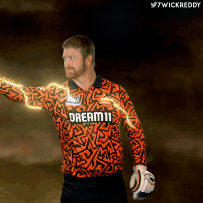 A Man Wearing An Orange Jersey That Says Dream11 On It GIF