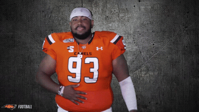 A Man Wearing An Orange Jersey With The Number 93 GIF