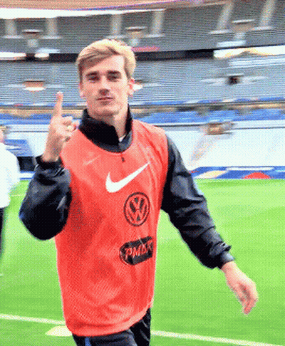 A Man Wearing An Orange Nike Vest With A Vw Logo GIF