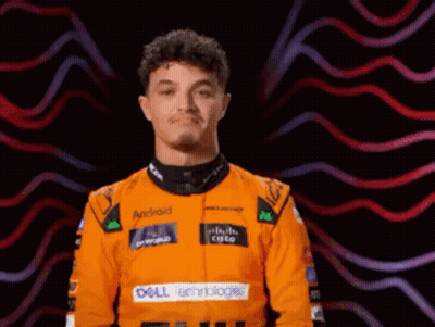 A Man Wearing An Orange Racing Suit With Dell Technologies On The Front GIF
